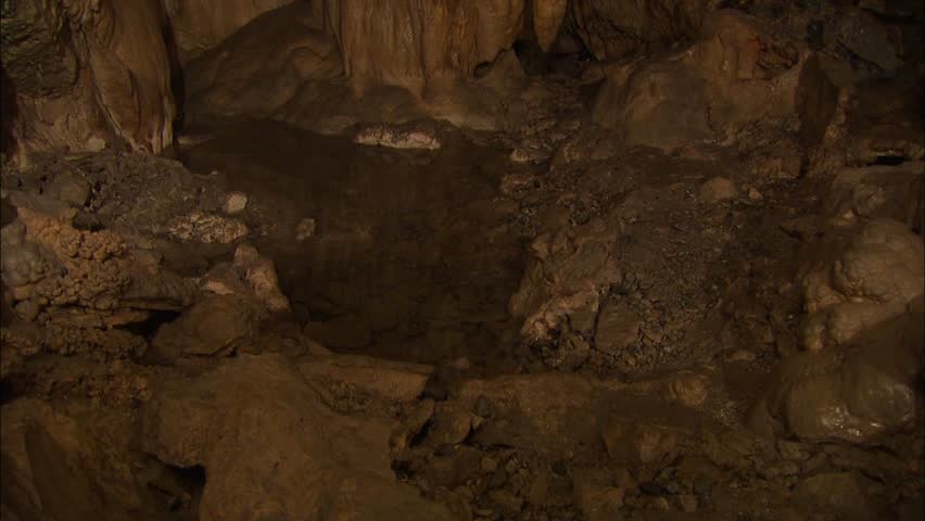 Cavern with stalactites and pool of water 