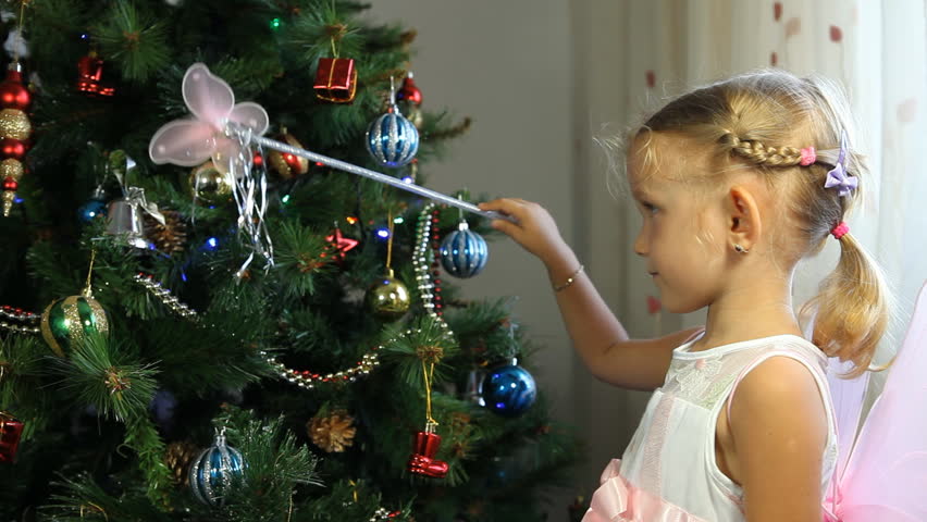 Child Touching, Playing with her Magic Wand on the Christmas Tree, Little Girl Playing with her Wand by the Christmas Tree