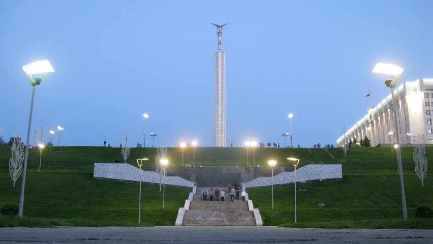 SAMARA - MAY 6: (Timelapse View) Tourists walk near Glory Monument on Glory Square in Samara in evening, on May 6, 2012 in Samara, Russia 