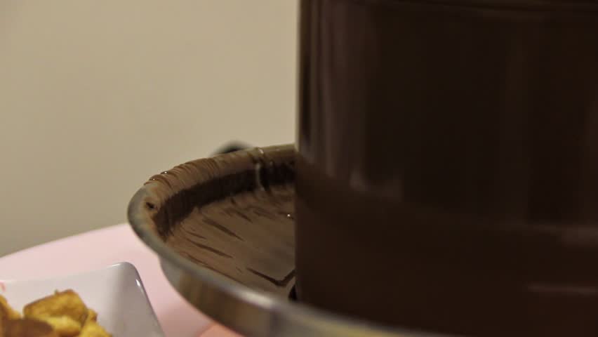Dipping Skewer in Chocolate Fountain