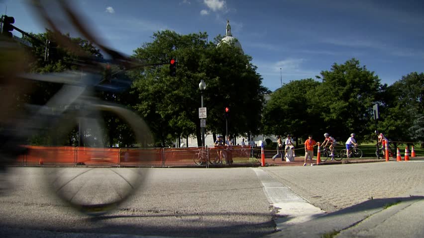 PROVIDENCE, RHODE ISLAND - SEPTEMBER 3, 2009: Pack of women bicycle racers rounding street corner in race - slow motion
