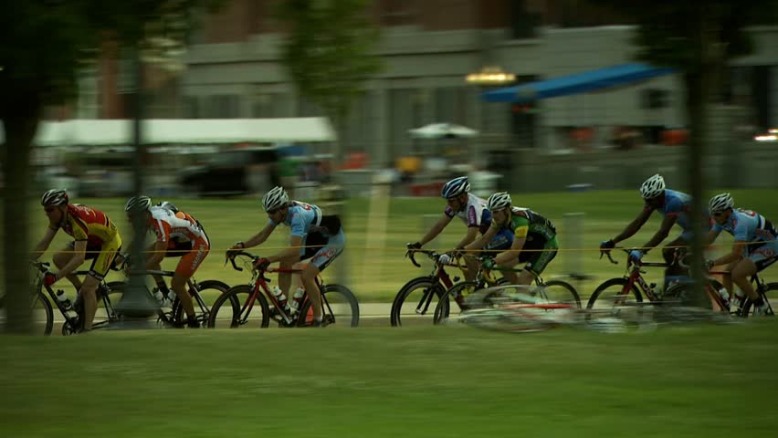 PROVIDENCE, RHODE ISLAND - SEPTEMBER 3, 2009: Several bike racers passing camera at high speed -- camera pans to track