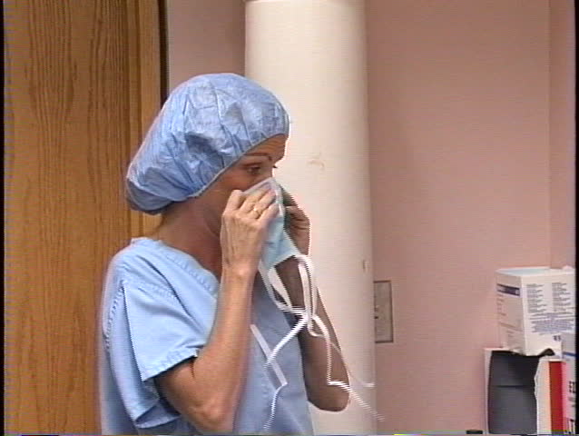 Nurse puts on a mask