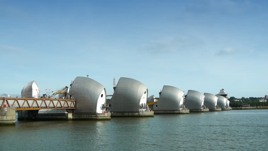The Thames flood defense barrier with a fast boat passing through.