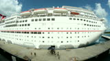 COZUMEL, MEXICO - July, 2012 The cruise ship Carnival Paradise as seen from the Carnival Elation as it leaves port at Cozumel, Mexico. MAY BE SUITABLE FOR EDITORIAL USE ONLY.