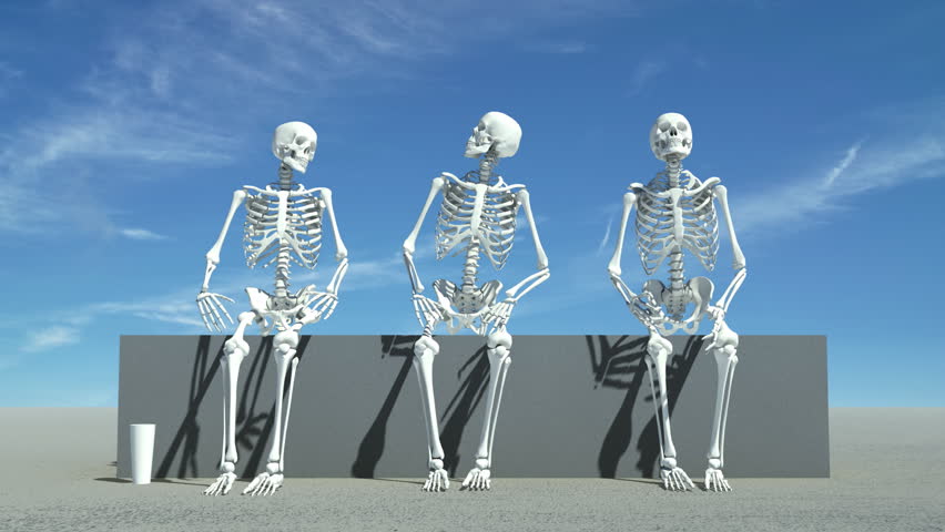 Three skeletons sitting down watching something, maybe a sports event, maybe life.