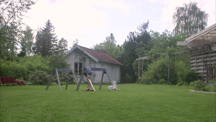 A woman doing carpentry in a garden