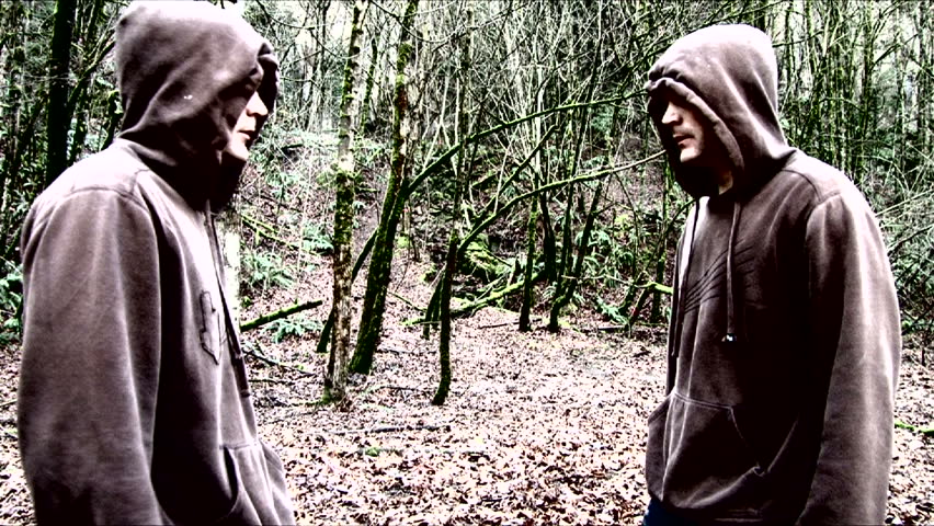 Twins running fast through eerie forest appear side by side breathing heavily, then run off.