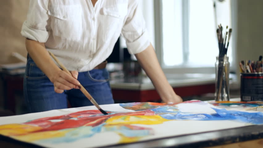 Woman artist painting watercolor paints