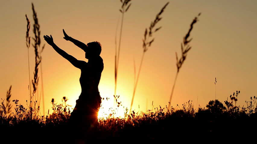 Young man training martial arts at sunset