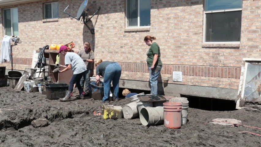 FOUNTAIN GREEN, UTAH 30 JUL 2012: Home house flooded with water and mud from flash flood. Friends and volunteer help recover destruction. Destructive nature force. Property destroyed. Church service.