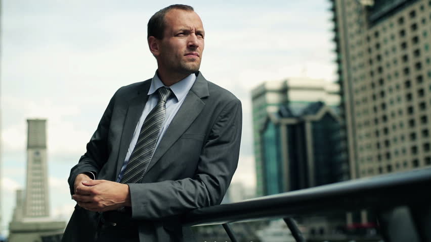 Portrait of young businessman relaxing in the city

