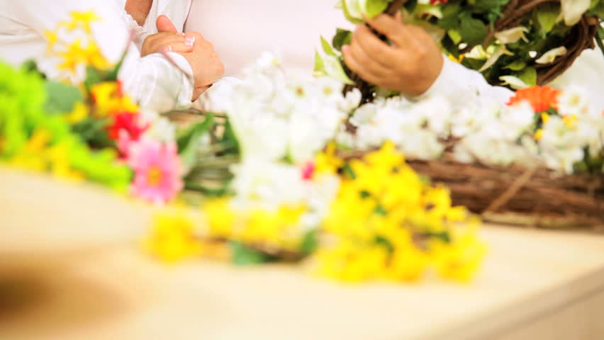 Attractive older ladies enjoying hobby time working with silk flowers home