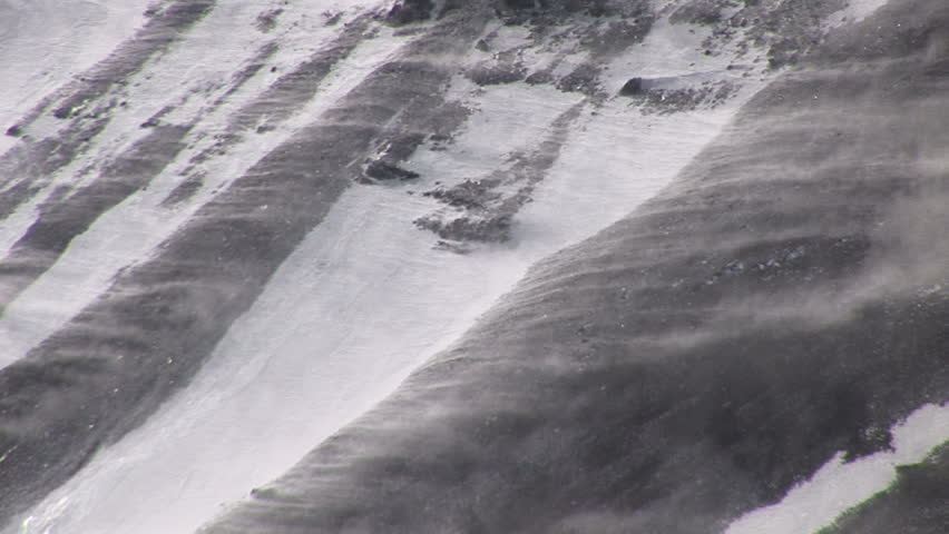 Wind blows snow on the slope of a mountain in the Andes, Chile.