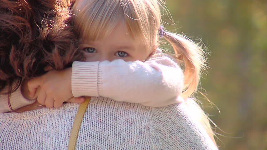 The happy little girl on hands of mum