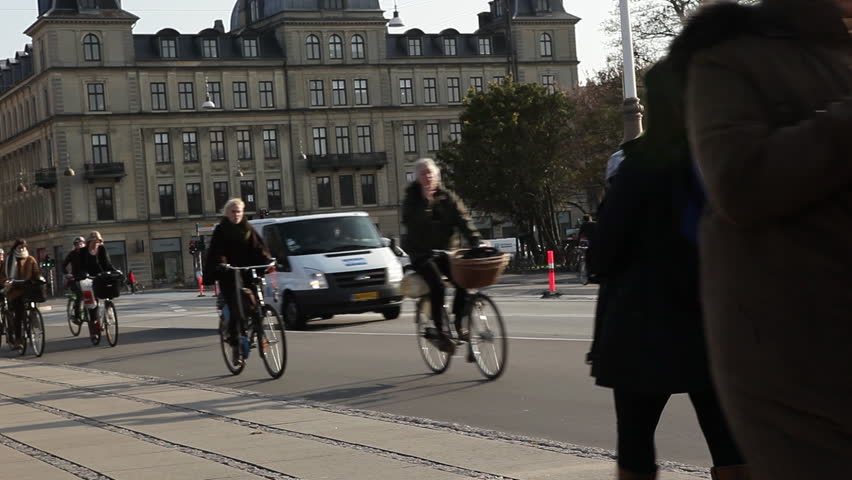 COPENHAGEN, DK - CIRCA 2011 -  Pedestrians and bicycle riders cruise down the street
