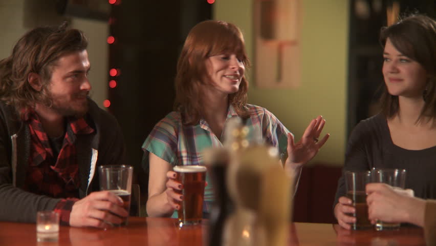 CU, PAN, Four friends sitting at a bar drinking beers when one woman proposes a toast