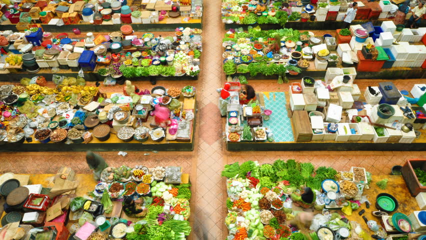 Vegetable market. Muslim woman selling fresh vegetables at market in Kota Bharu, Malaysia