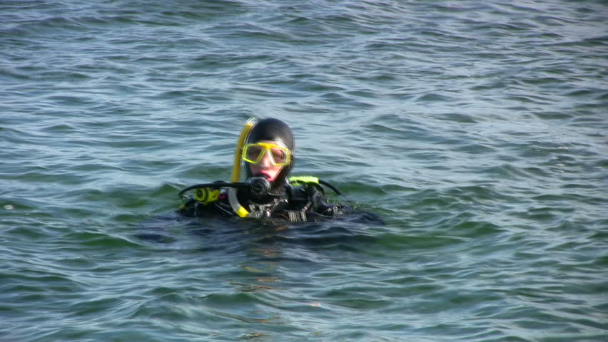 Scuba diver preparing a dive and diving