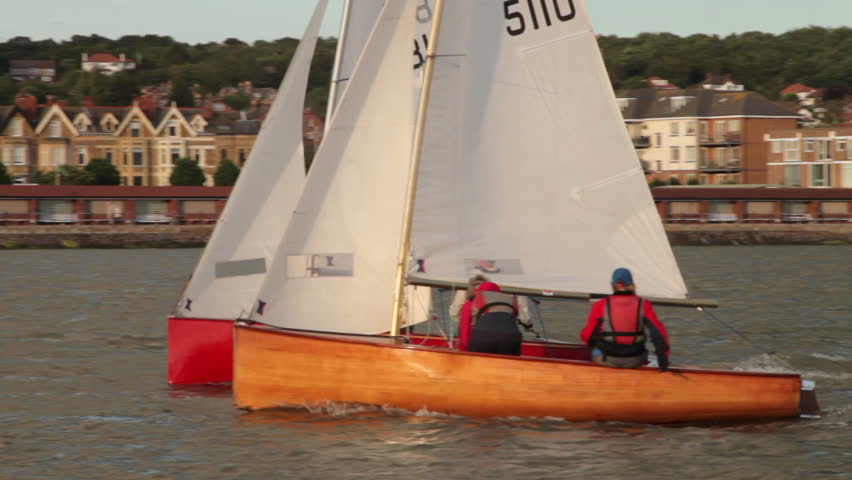 WEST KIRBY, WIRRAL/ENGLAND - JULY 11: Unidentified people race dinghies on lake on July 11, 2012 in Wirral. The Marine Lake is a man made coastal lake fed by the sea at high tide