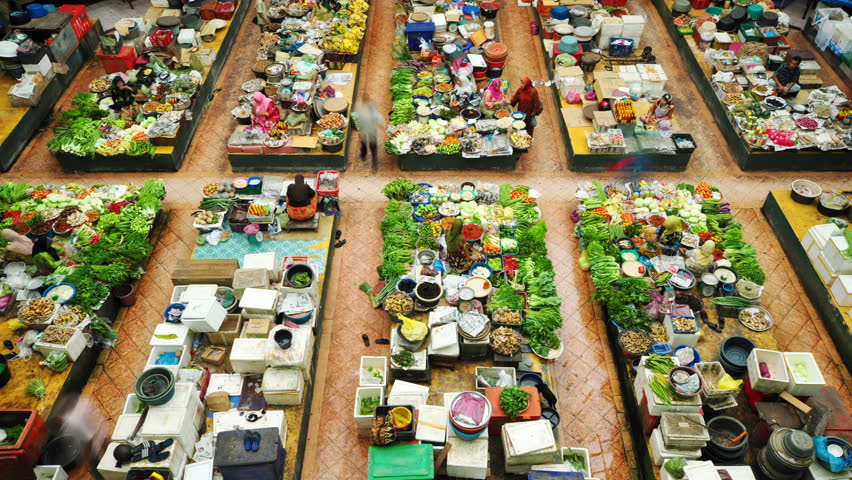 MALAYSIA - JANUARY 24: Time lapse of Muslim woman selling fresh vegetables at the traditional bazaar market Siti Khadijah Kota Bahru on January 24, 2011 in Kelantan, Malaysia. 