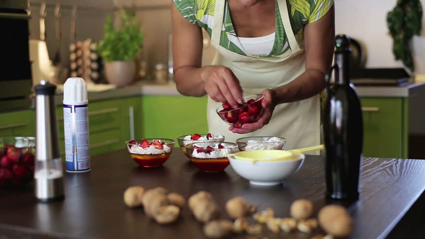 House wife decorating desserts in the kitchen

