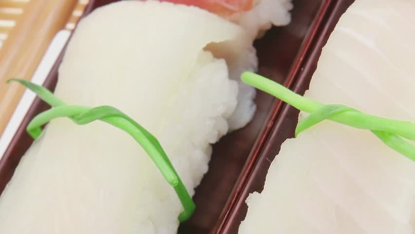 Japanese traditional cuisine - Set of Tuna (maguro) Salmon (sake) and Eel (unagi) Nigiri Sushi  with Wasabi  and Ginger on bamboo mat isolated over white background