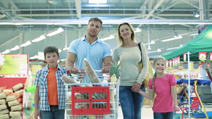 Smiling family of four enjoying shopping together