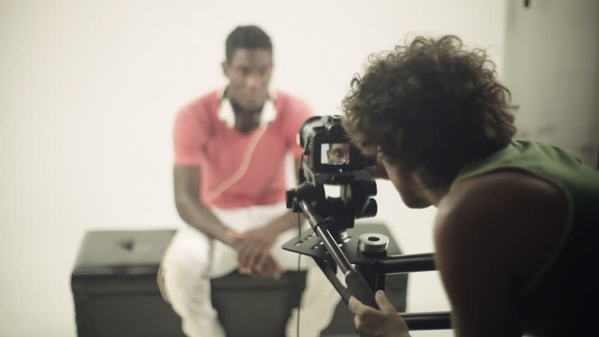 caucasian photographer shooting photos of african model