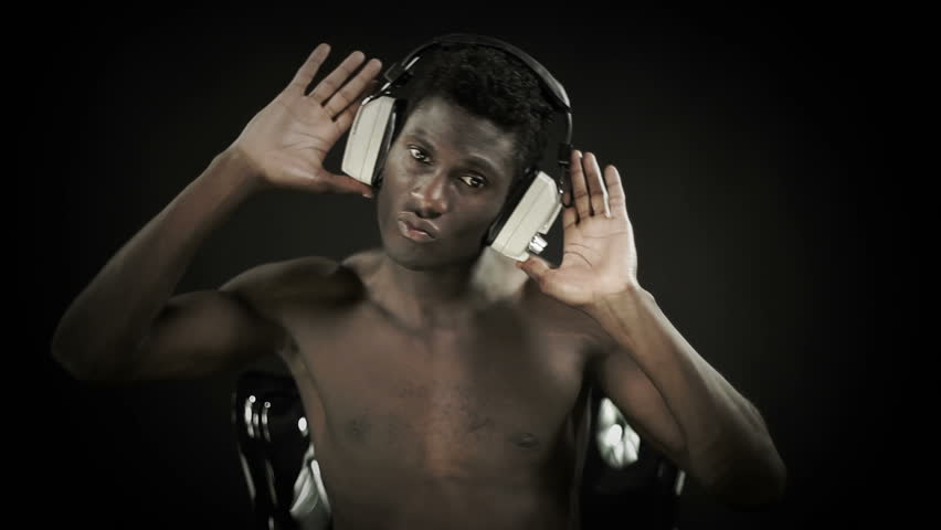 young african guy waving and dancing with a cool attitude while sitting and open hands