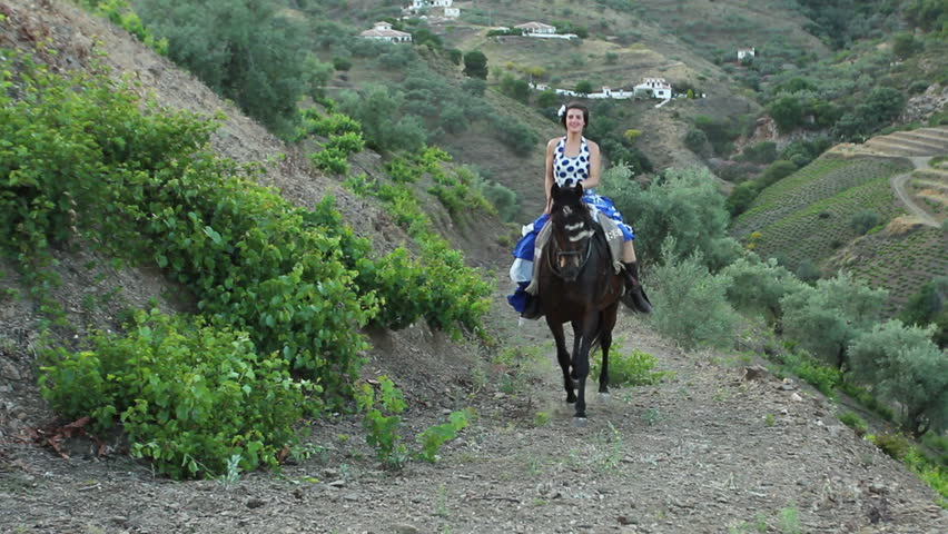 Woman riding a galloping horse in Andalusia, Spain