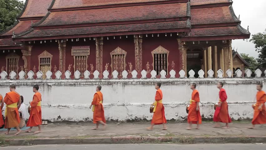 LUANG PRABANG, LAOS - OCTOBER 18: Buddhist Monks collecting morning offerings on October 18, 2009 in Luang Prabang, Laos. Processions like these are seen a over the town from sunrise. 