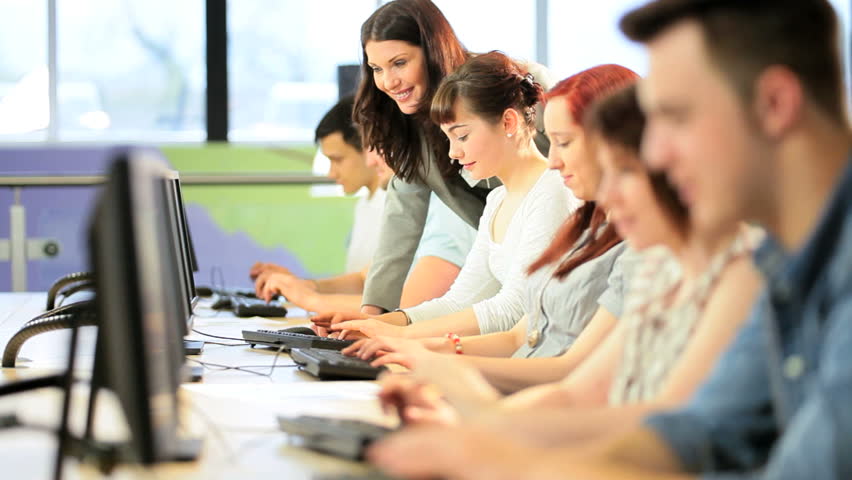 Group of multi ethnic classmates follow instructions Caucasian tutor in IT university class
