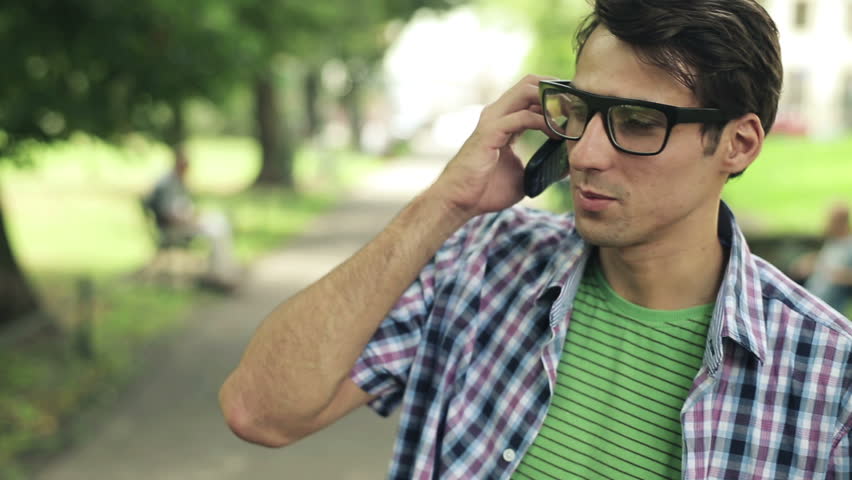Young man talking on cellphone in the park

