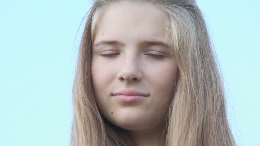 Young girl with brackets on teeth watch and smile, closeup view at summer day