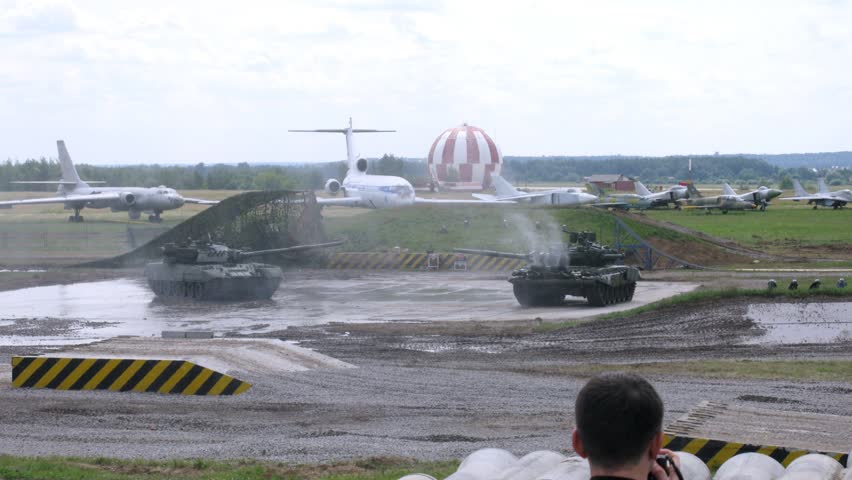 ZHUKOVSKY - JUN 25: (Timelapse View) Tanks carry out maneuvers before audience at second forum of Technology in mechanical engineering 2012 on airdrome Ramenskoe, on Jun 15, 2012 in Zhukovsky, Russia
