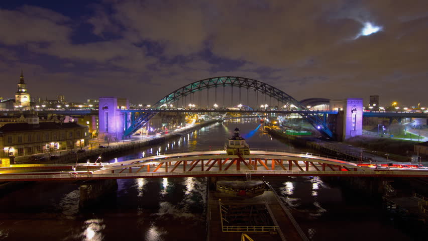 NEWCASTLE â CIRCA JANUARY 2012: Time lapse of the Millennium Bridge and the Sage Music Hall viewed from the Tyne Bridge, with early evening traffic going past in New Castle, England circa January 2012.