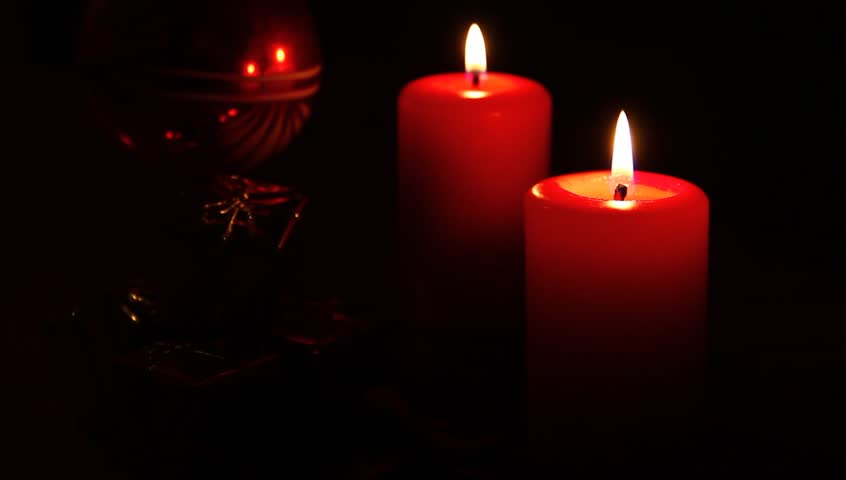 Two candles and Christmas decor.
