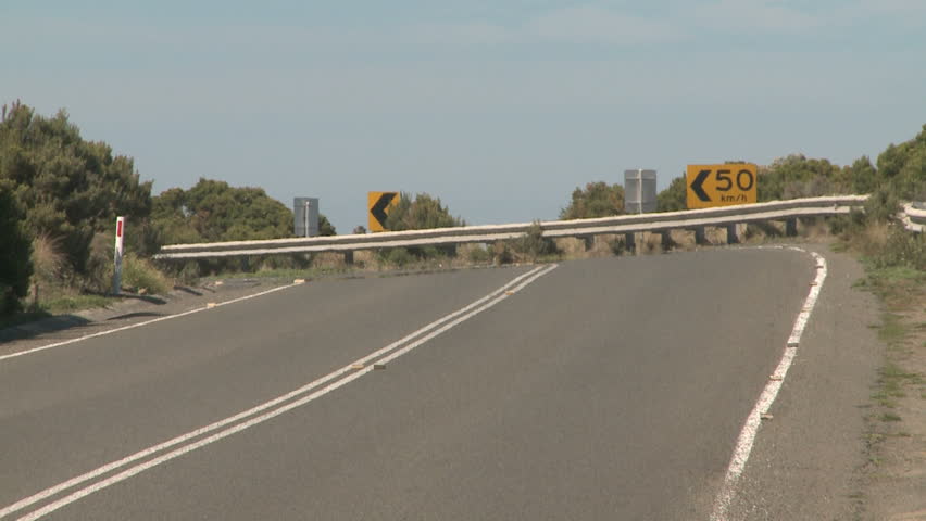 Great Ocean Road highway with lanes near South ocean in Australia, Victoria and the Sky with clouds in the background and heatmaze on the tarmac