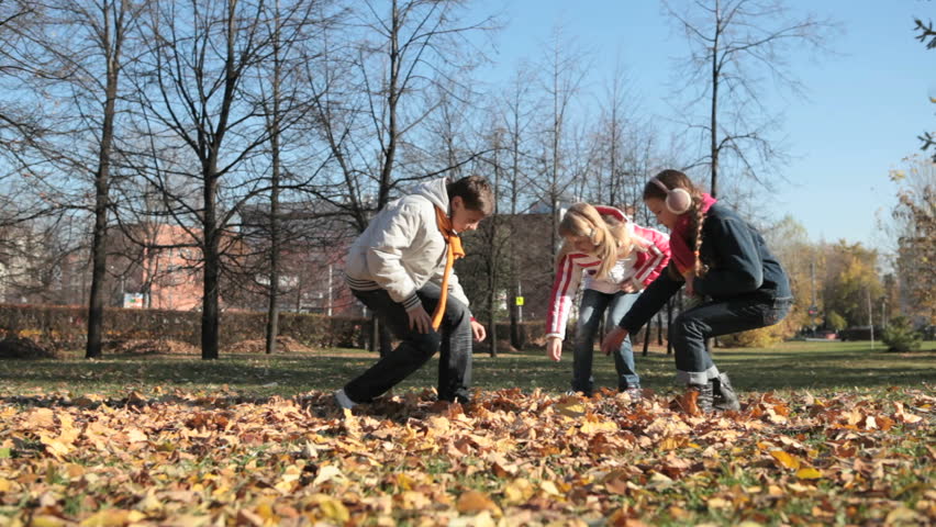 Schoolchildren gathering withered leaves for their homework