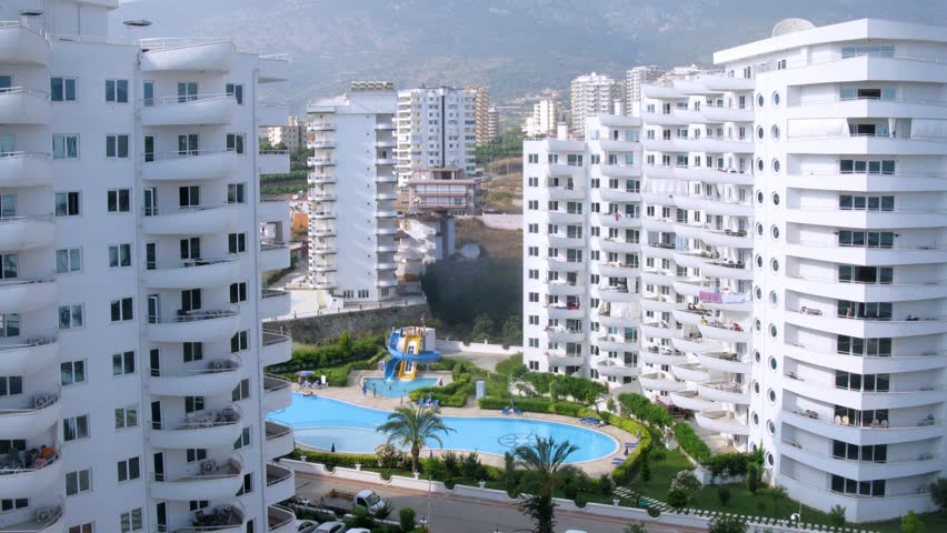 ALANYA - JUL 8: (Timelapse View) People swim in pool near housing estate My Marine Residence in afternoon, on Jul 8, 2012 in Alanya, Turkey. In Housing estate of My Marine Residence 381 apartments.