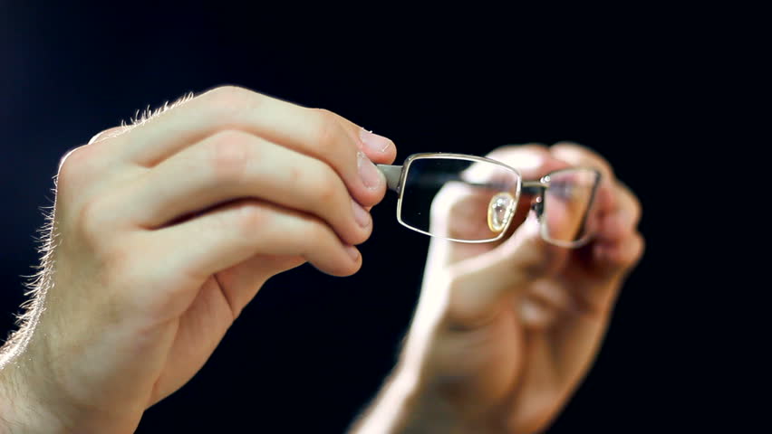 A man checking it's eyesight glasses. Very careful not to destroy the glass and framework of glasses, there is already a bit of error on the glasses. HD1080p.