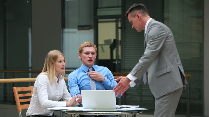 Experienced businessman explaining how to do business to the interns