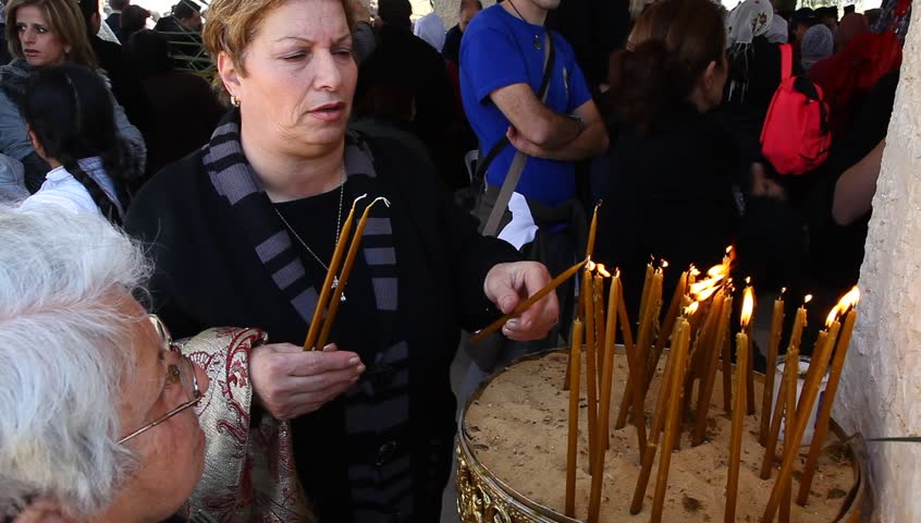 QASR AL YAHUD, ISRAEL â JANUARY 18: Greek Orthodox pilgrims lit candles at baptismal site during the Epiphany at Qasr Al Yahud, Israel, January 18 2012