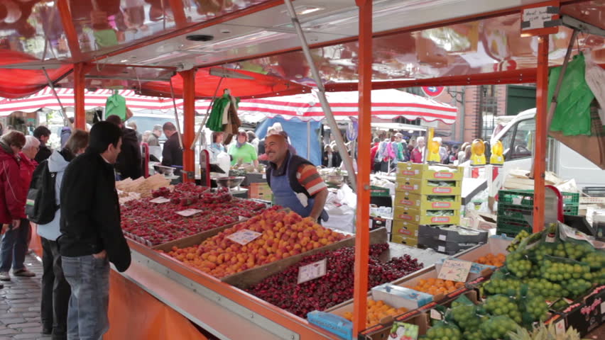 HAMBURG, GERMANY - JUNE 3, 2012: Fruit seller at Hamburg Fischmarkt. Every Sunday morning from 05:00 a.m. to 09:30 a.m. Hamburgâs historical and traditional Fish market takes place.