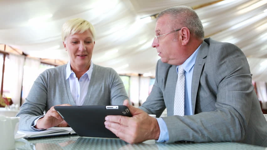 Senior businesspeople sharing ideas at lunch