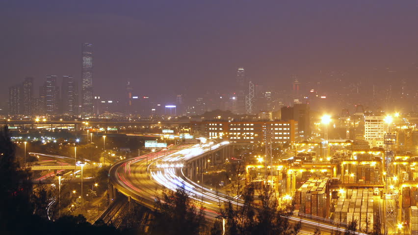 Hong Kong Skyline and Container Terminal at Night - Hong Kong Kwai Tsing Container Terminals is one of the busiest ports in the world.