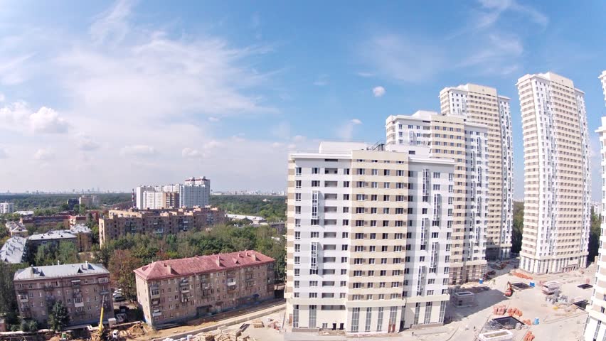 MOSCOW - AUG 6: (Timelapse View) Old five-floor house stands near Housing estate Ekopark Elk Island (Losiniy Ostrov) against blue sky, builder Donstroy, on Aug 6, 2012 in Moscow, Russia