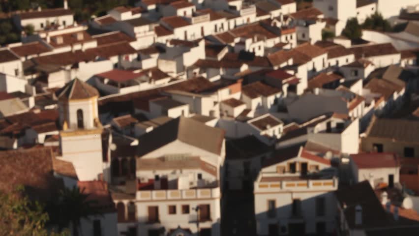 Church in spanish white village surrounded by mountains and trees. Pueblo blanco. Starting and ending blurred. Top view. Montejaque. Malaga. Andalusia. Spain.
