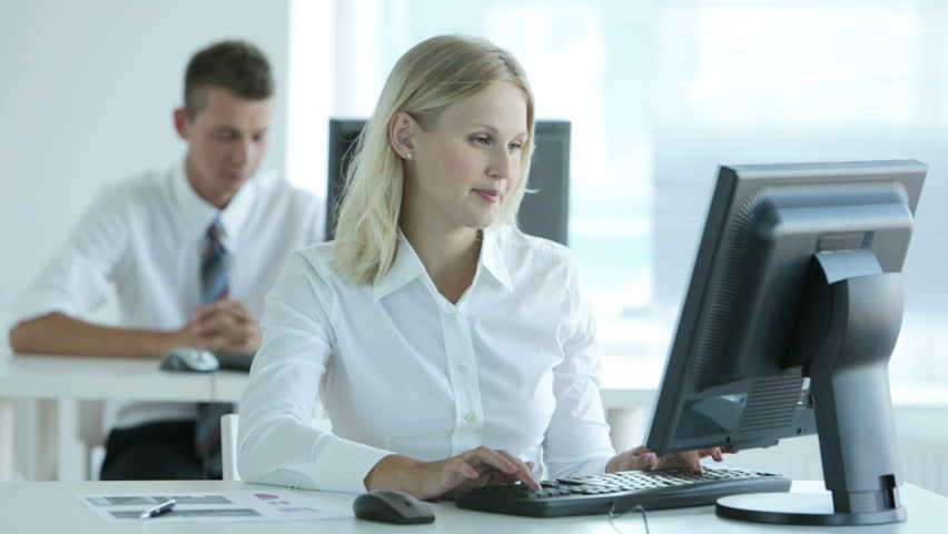 Female office clerk with positive attitude spending a usual working day in office